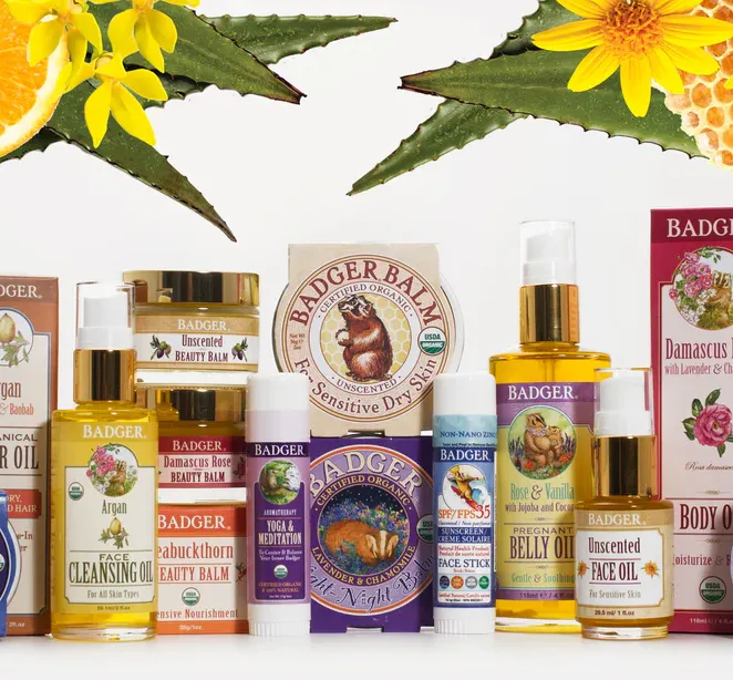 Clean Organic Products: Assorted Badger skincare products arranged in rows with citrus and flower decorations.