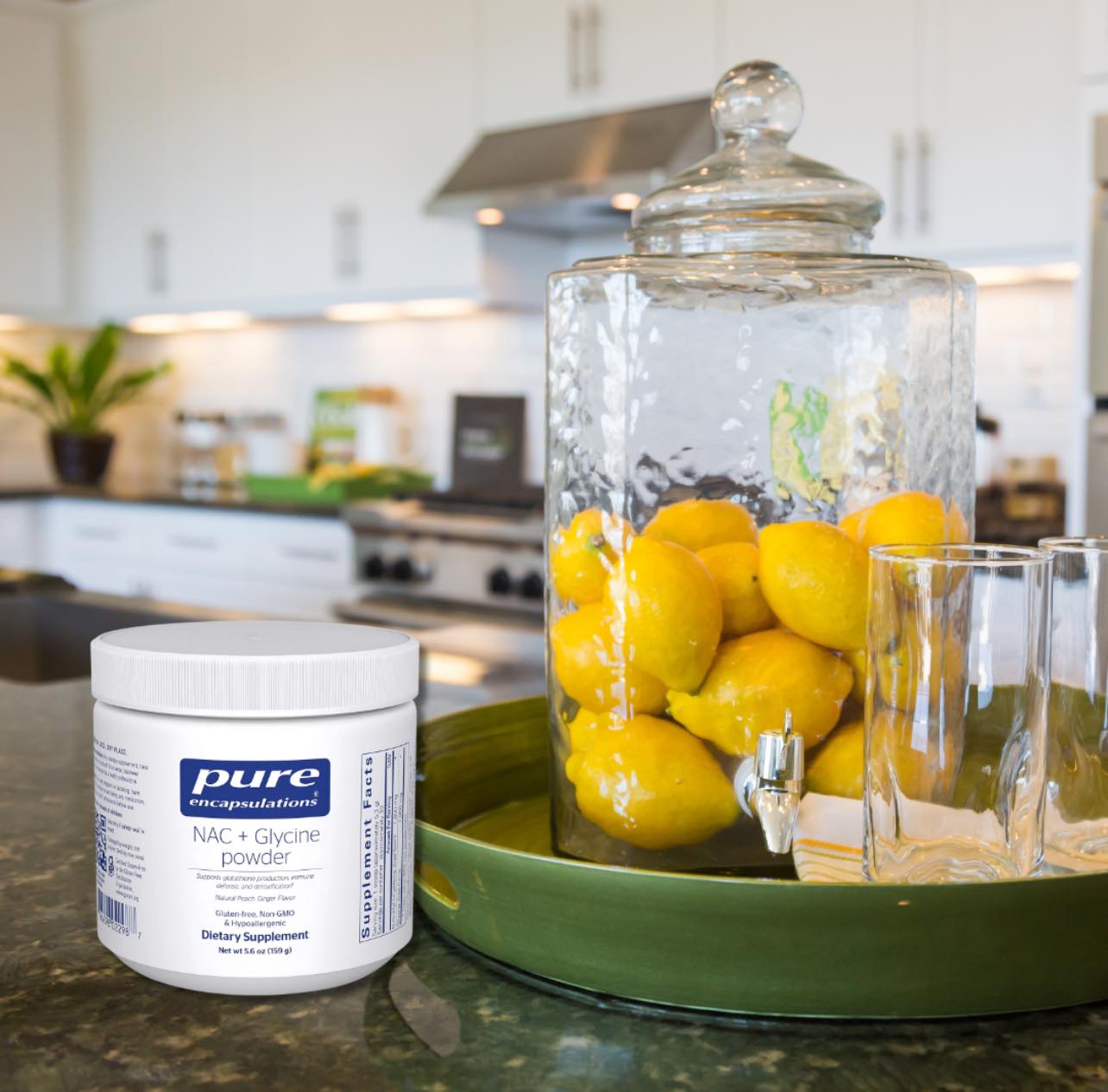 A kitchen scene with a jar of lemons and a container of NAC + Glycine powder on a counter.
